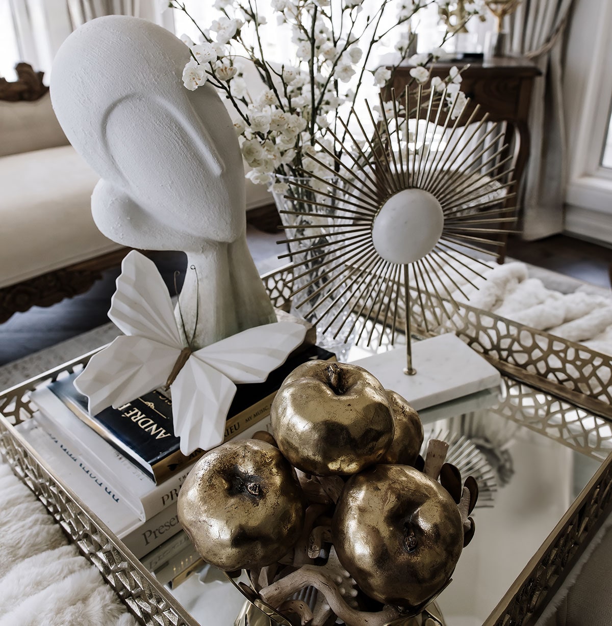 Living room with curved sofa, sculptural lighting and layered textures